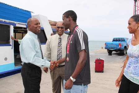 Permanent Secretary in the Ministry of Youth and Sports on Nevis Mr.  Alsted Pemberton welcomes Nevisian Athlete Adrian Williams on his return to Nevis after a successful performance at the Commonwealth Youth Games in the Isle of Man