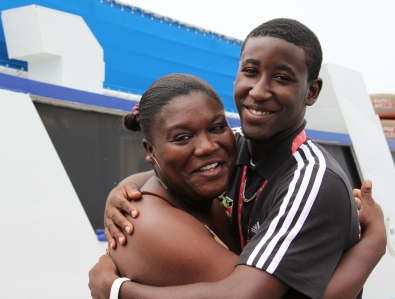 Adrian Williams embraces the official chaperon of his Gladiators Track Club Ms. Rovina Jeffers