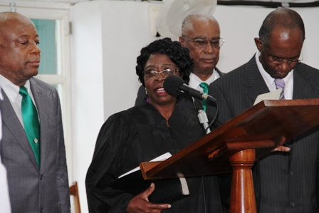 New Speaker of the Nevis Island Assembly takes the oath with Clerk of the House Mr. Dwight Morton. Witnessing the occasion are (back l-r) Deputy Premier Hon. Hensley Daniel and Premier of Nevis Hon Joseph parry)