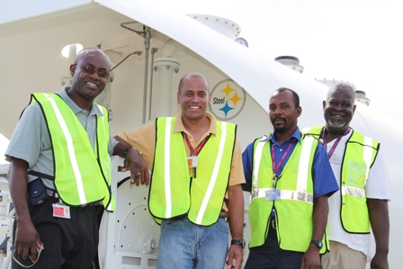(L-R) General Manager of the Nevis Air and Seaports Authority Mr. Spencer Hanley, General Manager of the Airport at Newcastle Mr. Steven Henley, Re-fueller at the Airport Mr. Trevor Powell and Head of Security at the Nevis Air and Seaports Authority Mr. Elroy Hendrickson with the newly installed AV-Gas tank in the background