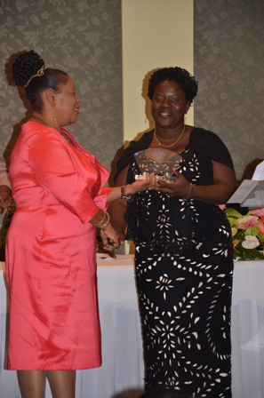 Mrs. Suzette Sampson of the Violet O. Jeffers Nicholls Primary School receives plaque from Mrs. Sonita Daniel wife of Deputy Premier Hon. Hensley Daniel 