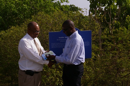 Premier of Nevis, Hon. Joseph Parry receiving cheque from CEO of SIDF-Mr. Terrance Crossman