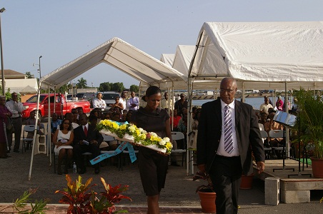 Premier Parry and Protocol officer Miss Dominique Honders placing wreath at Christena memorial