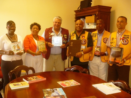  (L-R) Mrs. Marva Roberts from the Nevis Library Services, Director of the Nevis Library Services Mrs Sonita Daniel, District Governor Zone 60B Mr. Claudius ‘Tony’ Boncamper MJF, Zone Chairman of the Antigua Lions Club Mr. Lester Ephraim, President of the Nevis Lions Club Mr. Cartwright Farrell and Immediate Past president of the Nevis Lions Club Mr. Ernie France show off books donated by the Lions Club
