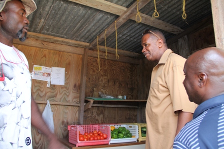 Acting Permanent Secretary in the Ministry of Agriculture Mr. Eric Evelyn (middle) and Minister of Agriculture in the Nevis Island Administration Hon. Alexis Jeffers (right) visit the onsite shop of Farmer Ellis Philip after a tour of his farm at Potworks