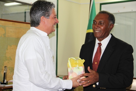 New Venezuelan Ambassador to St. Kitts and Nevis His Excellency Romolo Camilo Henriquez Gonzalez presents Premier of Nevis Hon. Vance Amory with a gift during a courtesy call at his Bath Hotel on April 23, 2013