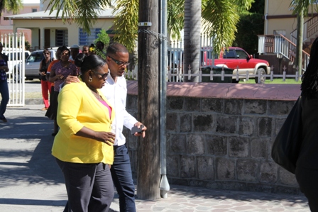 Senior and Junior Ministers of Health on Nevis Hon. Mark Brantley and Hon. Hazel Brandy-Williams conversing during the march through Charlestown in observance of World AIDS Day 2013
