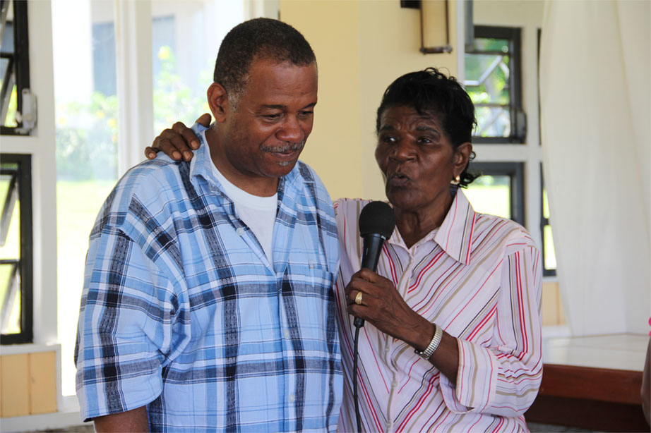 President of the Empire Sports Club Mr. Eric Evelyn gets an appreciative hug from one of the senior citizens of Hanleys Road following an island tour and luncheon at Mount Nevis Hotel on December 13, 2013