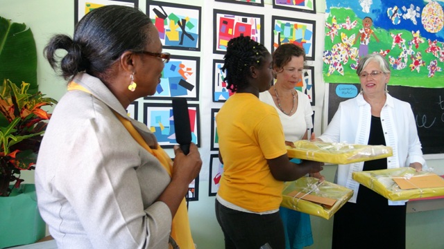 Elizabeth Pemberton Primary School Principal Marion Lescott (extreme left) with Grade 5 student Kalianne Smith presents gifts to certified Art teachers of the Glen Urquhart School in Massachusetts Catherine Cobb and Sandra Thoms at the opening ceremony of an art exhibition at the School on March 07, 2014