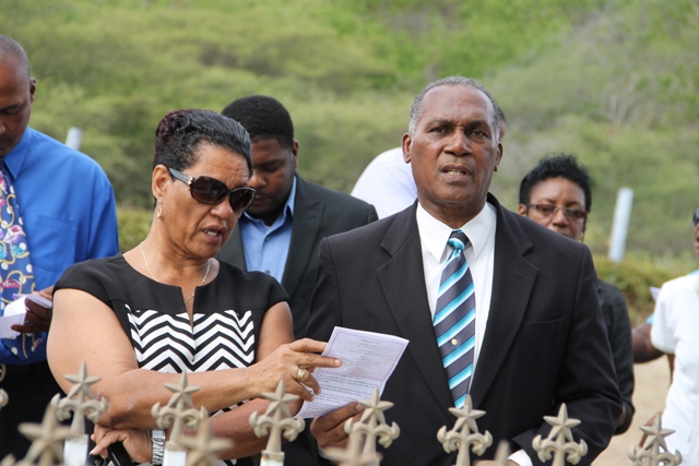 Widow of the late Malcolm Guishard Yvonne Guishard singing hymns at the gravesite of the late Malcolm Guishard during a memorial service at the Bath Cemetery on June 11, 2014. Guishard had served as Deputy Premier in the Nevis Island Administration before his passing seven years ago