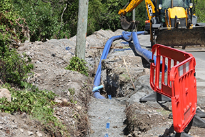 Laying water pipes on the Island Main Road in Maddens under the Nevis Water Supply Enhancement Project