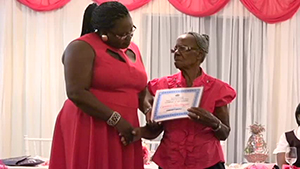 Ms. Lucina “Mama Lou” Dore of Charlestown accepting an award from Junior Minister responsible for Social Development on Nevis Hon. Hazel Brandy-Williams, for her contribution to entrepreneurship at the Gala and Awards ceremony, hosted by the Department of Social Development, Seniors Division on October 23, 2014