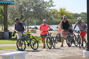 More cruise visitors to Nevis leaving the Charlestown Waterfront for a bicycle tour moments after they were brought to shore on November 19, 2014 