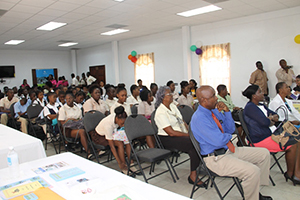 Front row (L-R) Cabinet Secretary in the Nevis Island Administration Steadmond Tross, Permanent Secretary in the Ministry of Education Lornette Queeley- Connor and Permanent Secretary of Human Resources Ornette Herbert with students from the Charlestown and Gingerland Secondary Schools at the Nevis Public Library’s 8th annual International College Fair on November 17, 2014, at the St. Paul’s Anglican Parish Hall