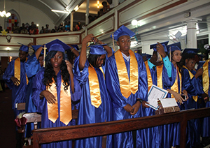 The Charlestown Secondary School Graduating Class of 2014 turn their tassels during their graduation ceremony at the Charlestown Methodist Church on November 12, 2014