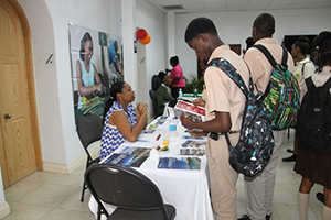 Students interacting with university representatives at the Nevis Public Library’s 8th annual International College Fair on November 17, 2014, at the St. Paul’s Anglican Parish Hall