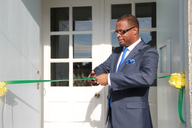 Minister of Tourism Hon. Mark Brantley cutting the ribbon at the opening ceremony of the Nevis Tourism Authority Visitor Centre.