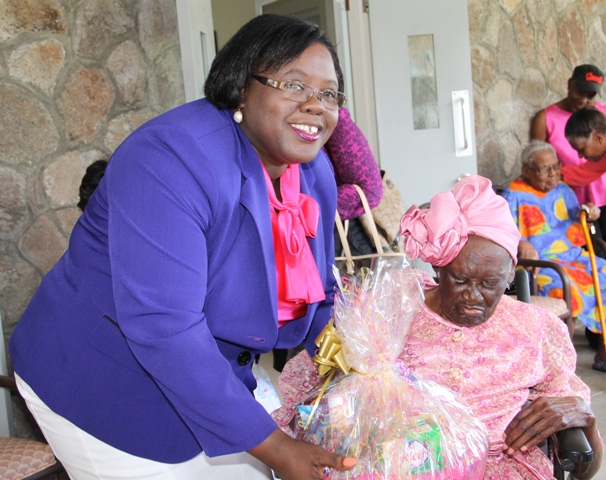 Minister of Social development who is responsible for the welfare of the seniors on Nevis Hon. Hazel Brandy-Williams hands over a fruit basket to 103-year-old Celian “Martin” Powell during her birthday celebration on January 19, 2015, at the Flamboyant Nursing Home