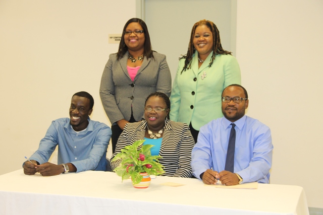 Junior Minister responsible for the Department of Youth and Sports Hon. Hazel Brandy-Williams (seated second from left) with personnel at the department. (Seated left) Stephan Joseph, (seated right) Acting Director of Sports Jamir Claxton (standing L-R) Coordinator of Youth Development Zhanela Claxton and Assistant Permanent Secretary in the Ministry of Social Development D. Michelle Liburd at the Department of Youth and Sports website launch on February 09, 2015 at the Emergency Operations Centre at Long Point