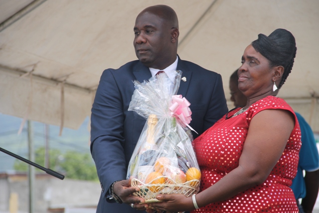 Minister of Agriculture on Nevis Hon. Alexis Jeffers presents a gift basket to Patron of the Department of Agriculture’s 21st annual Open Day Roslyn Cranston at the opening ceremony at the Villa in Charlestown on March 26, 2015