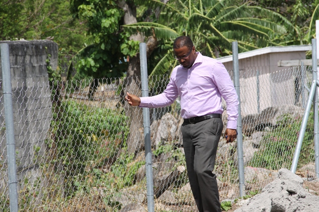 Deputy Premier of Nevis Hon Mark Brantley walking along recently fence area
