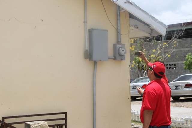 Member of the Venezuelan delegation assessing the electricity supply at the Charlestown Secondary School on June 04, 2015