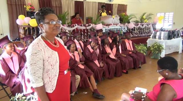 Veteran Educator on Nevis Marion Lescott with the graduating class of 2015 at their recent graduation ceremony of the Elizabeth Pemberton Primary School at the United Pentecostal Church, Marion Heights