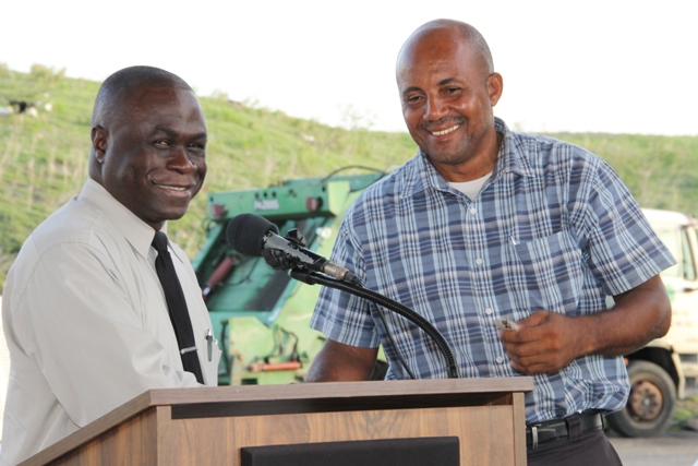 General Manager of the Nevis Solid Waste Management Authority Andrew Hendrickson handing over keys to two state-of-the-art Kenworth garbage collection trucks to Operations Manager Dennis “Rudy” Browne at a handing over ceremony at the Long Point landfill on September 17, 2015