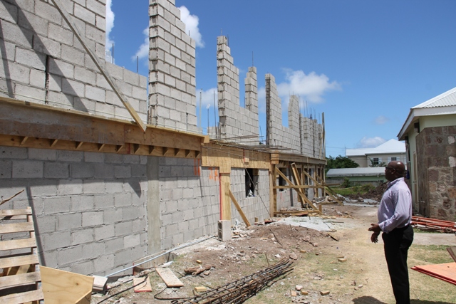 The back view of ongoing construction work for the expansion of the Joycelyn Liburd Primary School showing storage areas