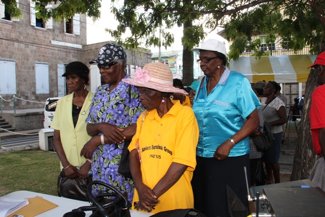 Seniors line up to receive their identification cards for the Ministry of Social Development’s Seniors Subsidized Transportation Programme which was launched at the Memorial Square in Charlestown on October 01, 2015