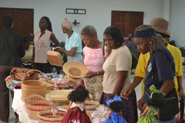 Seniors examining craft work done by their colleagues at a mini exhibition at St. Paul’s Conference Hall on October 12, 2015