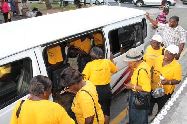 Some senior citizens boarding a public bus with the Nevis Bus Association logo after they received their identification cards on October 01, 2015, as part of the Ministry of Social Development’s Seniors Subsidized Transportation Programme