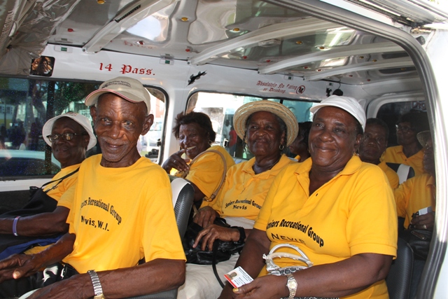 Seniors board a Nevis Bus Association vehicle for free travel on October 01, 2015, moments after the Ministry of Social Development’s Seniors Subsidized Transportation Programme was launched at the Memorial Square in Charlestown