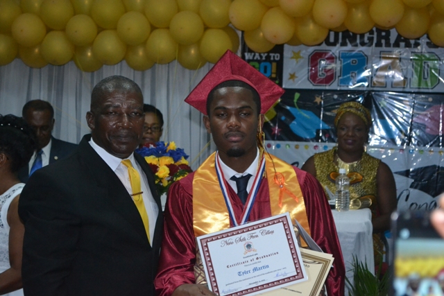 Valedictorian of the Nevis Sixth Form College Graduating Class of 2015 Tyler Martin with Principal Edson Elliot moments after he is presented with the Principal’s Medallion at the Charlestown Secondary School and the Nevis Sixth Form College at their Graduation and Prize-giving Ceremony at the Cicely Grell-Hull Dora Stevens Netball Complex on November 11, 2015
