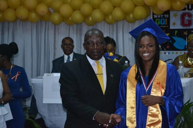 Valedictorian of the Charlestown Secondary School’s (CSEC) graduating class of 2015 Nekhaila Tyson with Principal Edson Elliot moments after she is presented with the Principal’s Medallion at the Charlestown Secondary School and the Nevis Sixth Form College at their Graduation and Prize-giving Ceremony at the Cicely Grell-Hull Dora Stevens Netball Complex on November 11, 2015