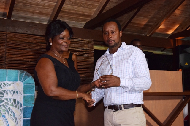 The Innovator Award being presented to Theon Drew by Premier of Nevis Hon. Vance Amory’s wife Mrs. Verni Amory, at the first IT Delta Awards on December 19, 2015, at the Nisbet Plantation Inn