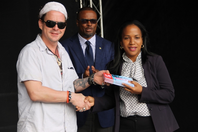 Permanent Secretary in the Ministry of Health Nicole Slack-Liburd receives tickets, to attend the opening night of Nevis Blues Festival, for nurses from renowned Blues singer Ian Seigal on behalf of organisers of the festival during a presentation ceremony at Oualie Bay on April 12, 2016