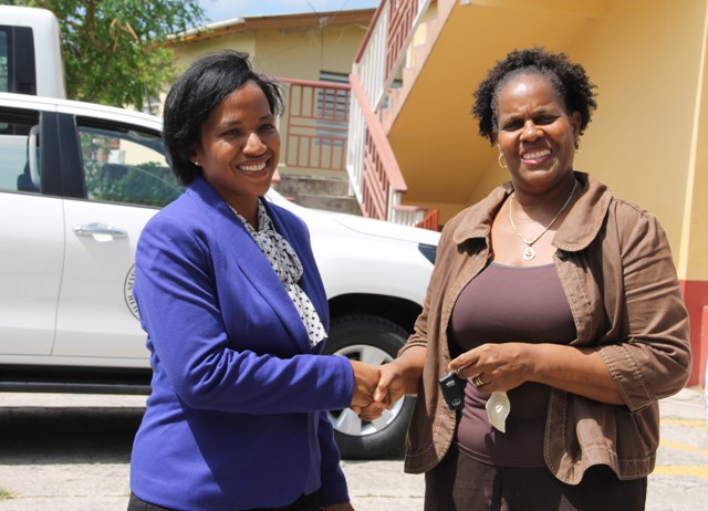 Permanent Secretary in the Ministry of Health on Nevis Nicole Slack-Liburd, hands over keys of a new Toyota truck to Medical Officer of Health Dr. Judy Nisbett, at a handing over ceremony at Government Headquarters in Charlestown, on August 30, 2016