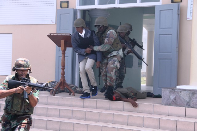 Officers of the Reserve Corps of the St. Kitts-Nevis Defence Force demonstrate their skills during a hostage situation at a training camp at the Elizabeth Pemberton Primary School at Cole Hill on August 25, 2016