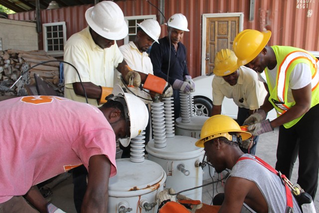  Linesmen from the Transmission and Distribution Department at the Nevis Electricity Company Limited, learning to wire transmitters at Prospect with (fourth from left) The Barbados Power & Light Company Limited’s Technical Trainer Curtis Brewster at Prospect on September 14, 2016 