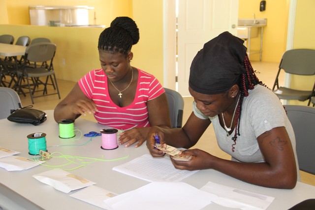 Other staff at the new Joycelyn Liburd Primary School (JLPS) cafeteria (l-r) Randelicia Chapman and Tesheba Freeman, preparing nametags for students on September 30, 2016, ahead of the first day of the School Meals Programme