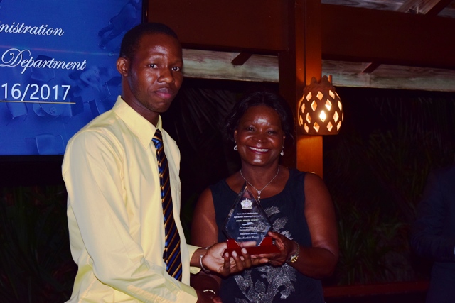 Craig David, Assistant Director at the Information Technology Department in the Nevis Island Administration, receiving the Ticketeer Award on behalf of Vanessa Tyson from Mrs. Verni Amory, wife of the Premier of Nevis Hon. Vance Amory, at the 2nd Annual Information Technology Department Delta Awards Dinner at the Nisbet Plantation Beach Hotel on February 18, 2017