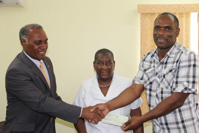 (l-r) Hon. Vance Amory, Premier of Nevis and Minister of Finance in the Nevis Island Administration hands over the cheque he received from St. Kitts and Nevis Sugar Diversification Foundation moments before from the Board of Counsellors Chairman Dr. Robertine Chaderton, to Permanent Secretary in the Ministry of Finance Colin Dore, at a handing over ceremony at the Ministry’s conference room in Charlestown on February 14, 2017.
