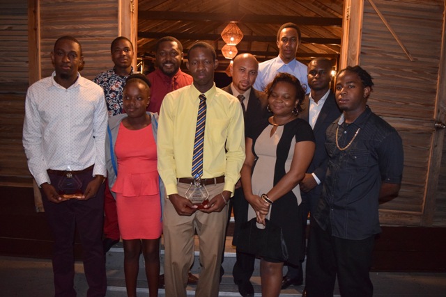 Jevon Claxton (front row extreme right) and Ezekiel Parris (front row second from left) showing off their awards with other members of staff of the Information Technology Department at the 2nd Annual Information Technology Department Delta Awards Dinner, at the Nisbet Plantation Beach Hotel on February 18, 2017