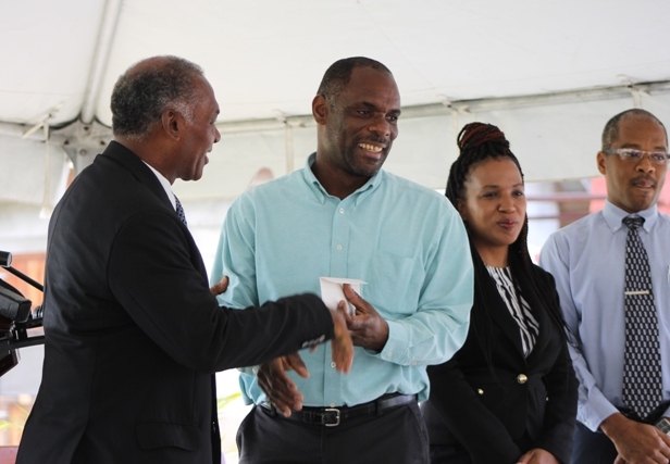 (l-r) Premier of Nevis and Minister of Finance Hon. Vance Amory hands over cheque from the Sugar Industry Diversification Fund to Permanent Secretary in the Ministry of Finance Colin Dore at the ground breaking ceremony on May 31, 2017, for construction of the $18million Alexandra Hospital Expansion Project. Permanent Secretary in the Ministry of Health Nicole Slack-Liburd and Hospital Administrator Gary Pemberton look on