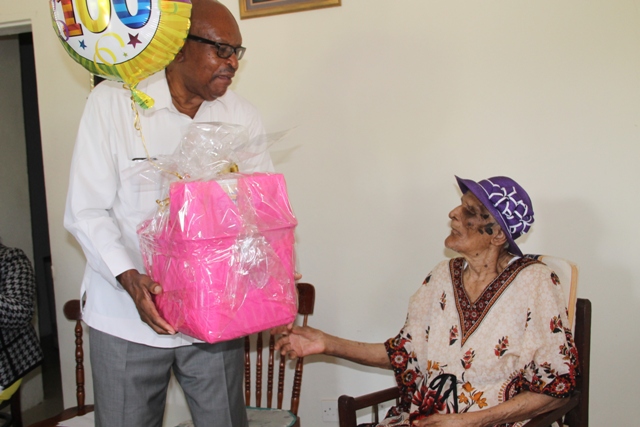 Governor General of St. Kitts and Nevis His Excellency Sir Tapley Seaton presents a gift basket to centenarian Eileen Swanston Smithen at her home in Zion Village, Gingerland on July 13, 2017, in celebration of her 100th birthday some weeks ago