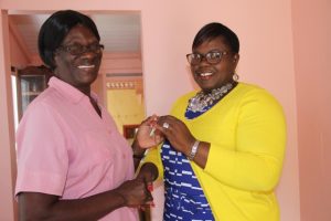 Hon. Hazel Brandy-Williams, Junior Minister in the Ministry of Social Development in the Nevis Island Administration (right) hands over the keys to Mrs. Yvonne Stanley of her newly renovated home at Fig Tree on October 19, 2017