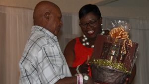 Hon. Hazel Brandy-Williams, Junior Minister in the Ministry of Social Development presents a gift basket to Mr. Norton Cornelius, one of five men honoured for their contribution to cultural preservation on Nevis