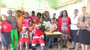 Students and staff of the Cecele Browne Integrated School with Ms. Shelagh James, Communications Officer in the Ministry of Tourism (extreme right), Mrs. Ilena Mills, Education Officer in the Department of Education who has responsibility for the school (second from right) and Mrs. Violet Clarke (third from right)