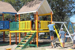 Members of the Galderma Group painting and repairing the play area as part of a gift to the Ivor Walters Primary School at Brown Hill on February 28, 2018